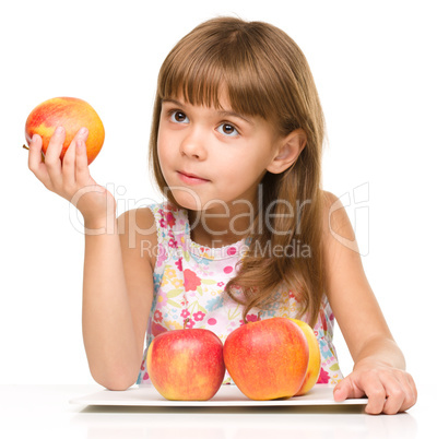 Little girl with red apples