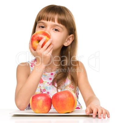 Little girl with red apples