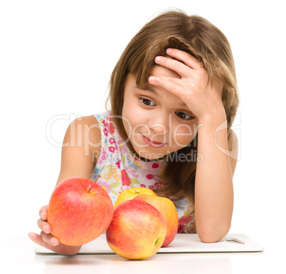 Little girl with red apples