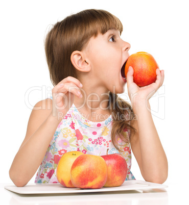 Little girl with red apples