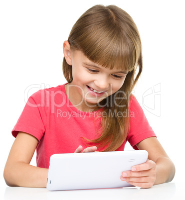 Young cheerful girl is using tablet