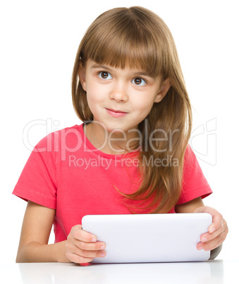 Young cheerful girl is using tablet