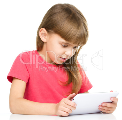 Young girl is using tablet while studying