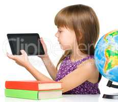 Young girl is showing tablet