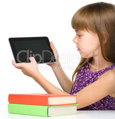 Young girl is showing tablet
