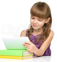 Young cheerful girl is using tablet