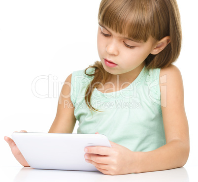 Young girl is using tablet while studying