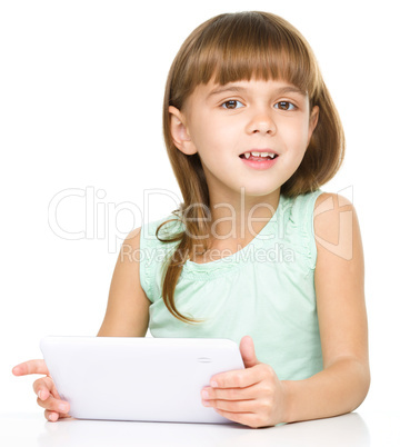 Young cheerful girl is using tablet