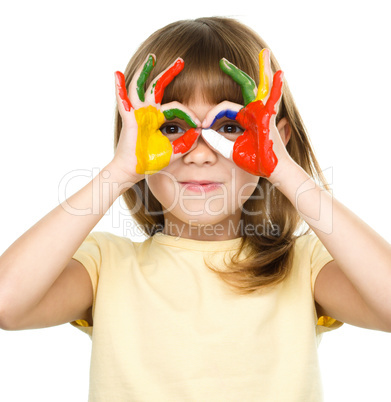 Portrait of a cute girl playing with paints