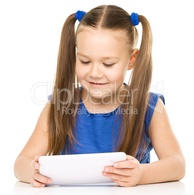 Young cheerful girl is using tablet