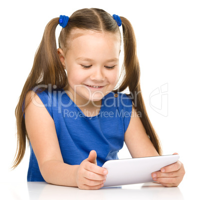 Young cheerful girl is using tablet