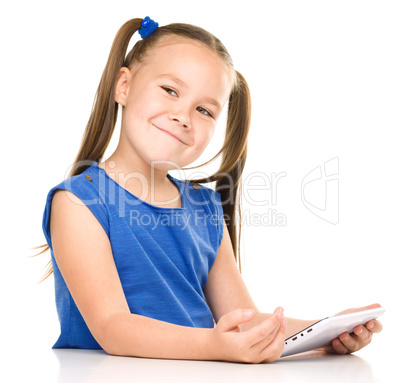 Young cheerful girl is using tablet
