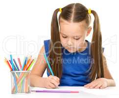 Little girl is painting with gouache