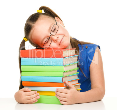 Little girl is sleeping on her books