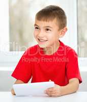 Young boy is using tablet