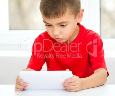 Young boy is using tablet