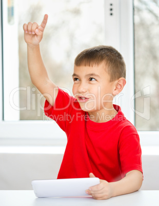 Young boy is using tablet