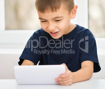 Young boy is using tablet