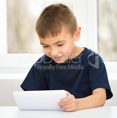 Young boy is using tablet