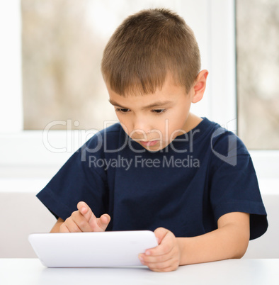 Young boy is using tablet