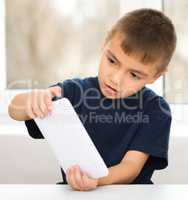 Young boy is using tablet