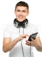 Young man enjoying music using headphones