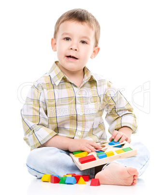 Little boy is playing with toys