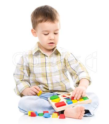Little boy is playing with toys