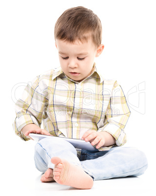 Young boy is using tablet