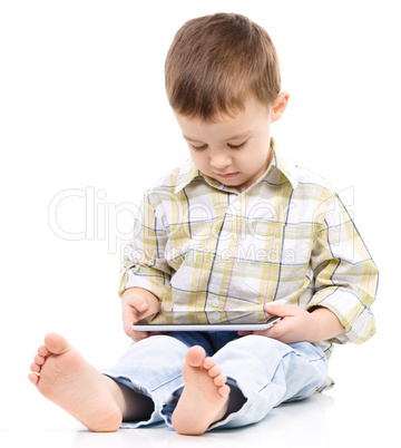 Young boy is using tablet