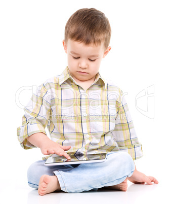 Young boy is using tablet