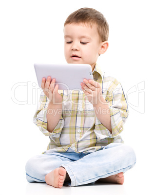 Young boy is using tablet