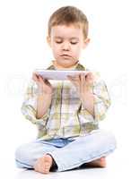 Young boy is using tablet