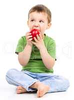 Portrait of a cute little boy with red apple