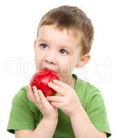 Portrait of a cute little boy with red apple