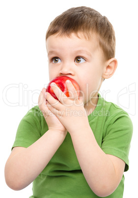 Portrait of a cute little boy with red apple