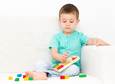 Boy is playing with puzzle