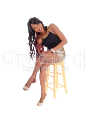 Young African American woman sitting on chair.