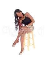 Young African American woman sitting on chair.