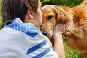 Boy kissing dog