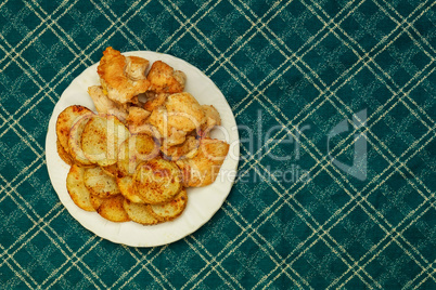 Stuffed roasted chicken wrapped in bacon with potatoes, carrots