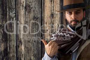 Gunfighter pointing on wooden table.