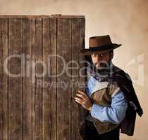 Gunfighter near wooden blank table.