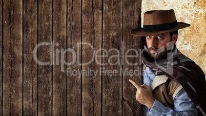 Gunfighter pointing on wooden table.