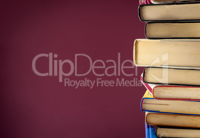 A pile of books on colored background