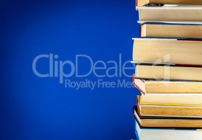 A pile of books on colored background