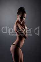 Studio photo of skinny girl in black thong panties