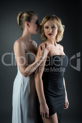 Two young beautiful women in cocktail dresses