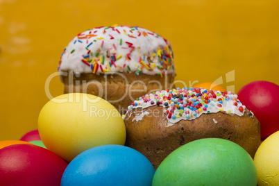 Easter eggs of different colors and cake