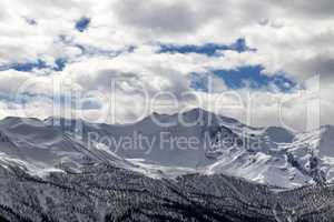 View on snowy mountains and cloudy sky in evening